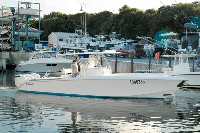  Yacht Photos Pics 2015 Bahama 34 boat docked at marina with other vessels in background.