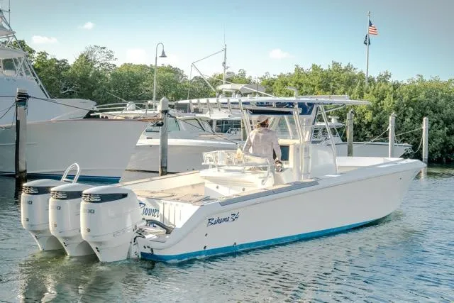  Yacht Photos Pics 2015 Bahama 34 boat with triple engines docked in a marina.