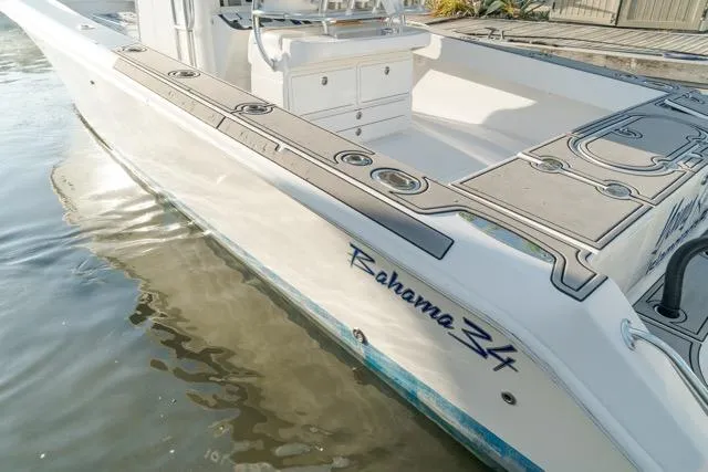  Yacht Photos Pics 2015 Bahama 34 boat docked, showcasing sleek design and spacious deck.