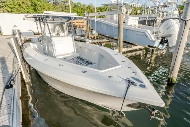  Yacht Photos Pics 2015 Bahama 34 boat docked in marina, featuring sleek design and spacious deck.