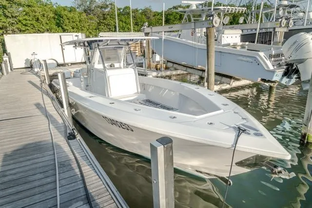  Yacht Photos Pics 2015 Bahama 34 boat docked at marina, featuring sleek design and spacious deck.