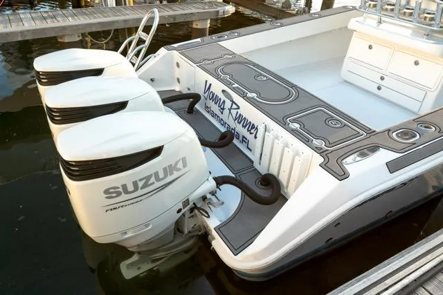  Yacht Photos Pics 2015 Bahama 34 boat with triple Suzuki outboard motors docked at marina.