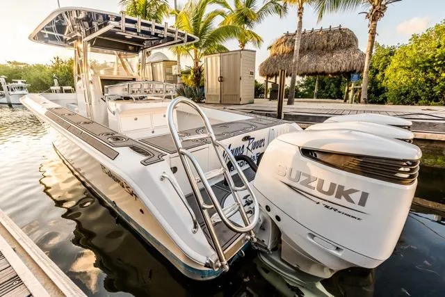  Yacht Photos Pics 2015 Bahama 34 boat docked with Suzuki engines, surrounded by tropical scenery.