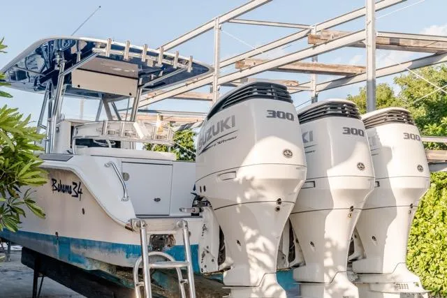  Yacht Photos Pics 2015 Bahama 34 boat with triple Suzuki 300 engines, docked outdoors.
