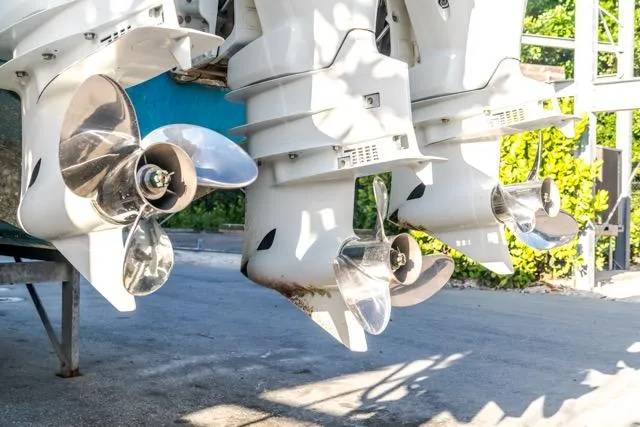  Yacht Photos Pics Outboard motors of a 2015 Bahama 34 boat, featuring shiny propellers.