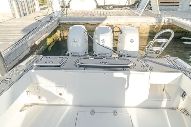  Yacht Photos Pics 2015 Bahama 34 boat with triple Suzuki outboard engines at dock.