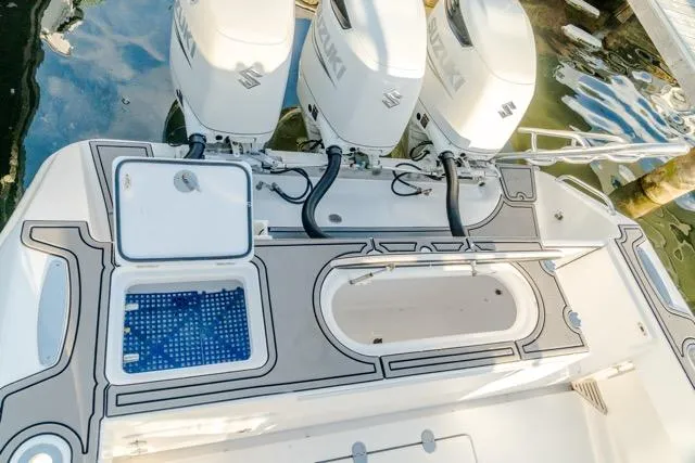  Yacht Photos Pics 2015 Bahama 34 boat with triple Suzuki outboard engines, featuring a sleek deck design.