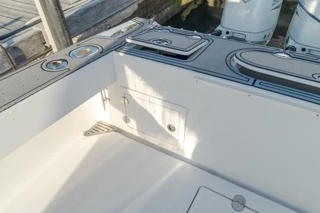 Yacht Photos Pics 2015 Bahama 34 boat deck with storage compartments and fishing rod holders.