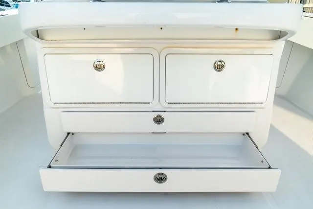  Yacht Photos Pics 2015 Bahama 34 boat storage compartments with open drawer, showcasing ample space.