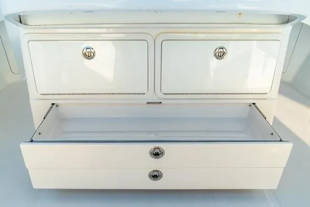  Yacht Photos Pics White storage drawers on a 2015 Bahama 34 boat, featuring sleek chrome handles.