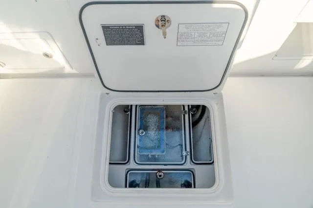  Yacht Photos Pics 2015 Bahama 34 boat compartment with open hatch, showcasing interior details.