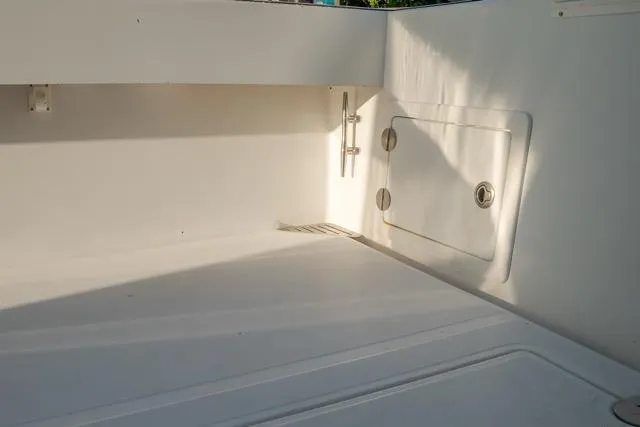 Yacht Photos Pics Interior view of a 2015 Bahama 34 boat, showcasing a clean, white storage compartment.