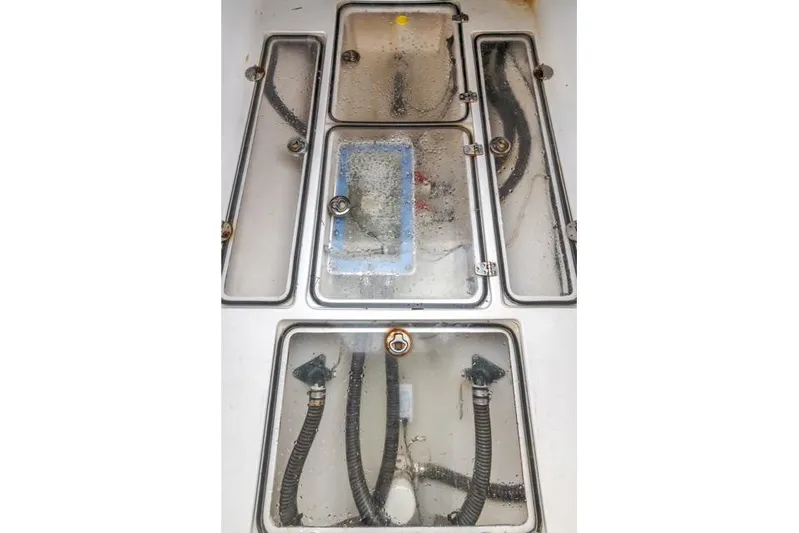  Yacht Photos Pics Engine compartment of a 2015 Bahama 34 boat with visible hoses and components.