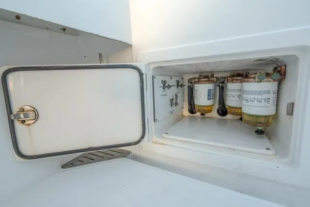  Yacht Photos Pics Fuel filter compartment of a 2015 Bahama 34 boat, showcasing maintenance access.