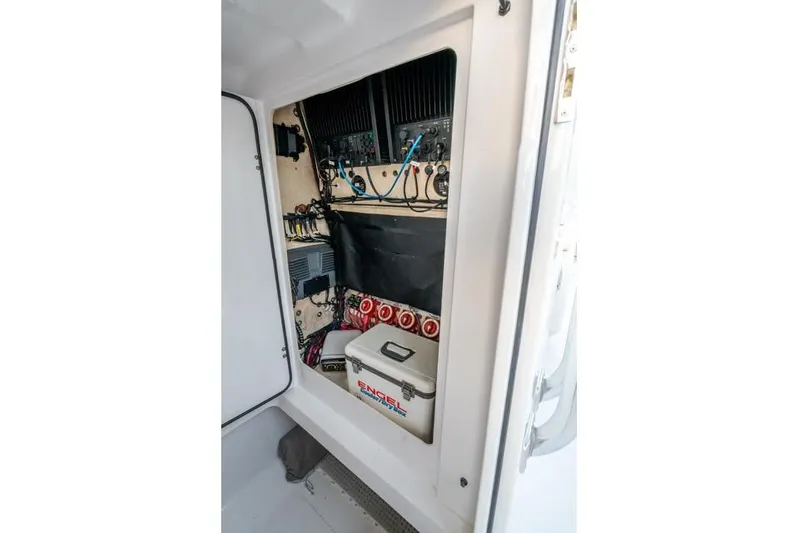  Yacht Photos Pics Electrical panel inside a 2015 Bahama 34 boat, featuring wiring and an Engel cooler.