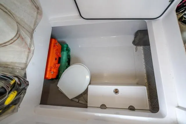  Yacht Photos Pics 2015 Bahama 34 boat interior with storage, toilet, and equipment cases.