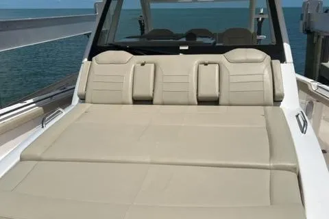  Yacht Photos Pics 2019 Pursuit S408 boat with beige seating, ocean backdrop.