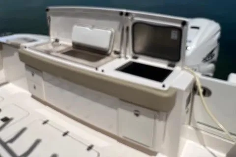  Yacht Photos Pics 2019 Pursuit S408 boat with open storage compartments and seating area.