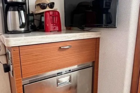  Yacht Photos Pics 2019 Pursuit S408 interior with coffee maker, red toaster, and small TV on countertop.