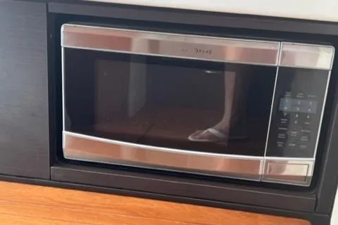  Yacht Photos Pics Built-in microwave oven with stainless steel finish in a modern kitchen setting.