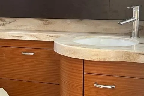  Yacht Photos Pics Modern bathroom vanity with wood cabinets and marble countertop in a 2019 Pursuit S408.
