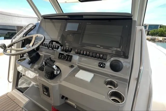  Yacht Photos Pics 2019 Pursuit S408 boat helm with steering wheel and control panel.