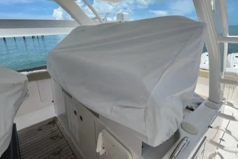  Yacht Photos Pics 2019 Pursuit S408 boat interior with covered equipment, ocean view in background.