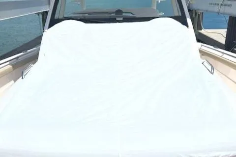  Yacht Photos Pics 2019 Pursuit S408 boat with a covered deck, docked on calm water.