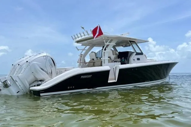  Yacht Photos Pics 2019 Pursuit S408 boat in shallow water with a dive flag.