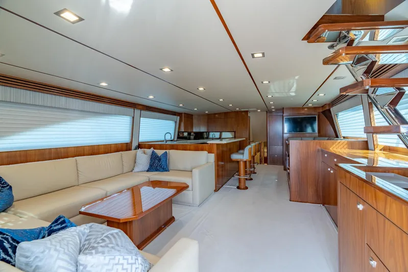 Reel Cents Yacht Photos Pics Luxurious interior of 2019 Viking 80 Enclosed Bridge yacht with elegant seating and modern design.