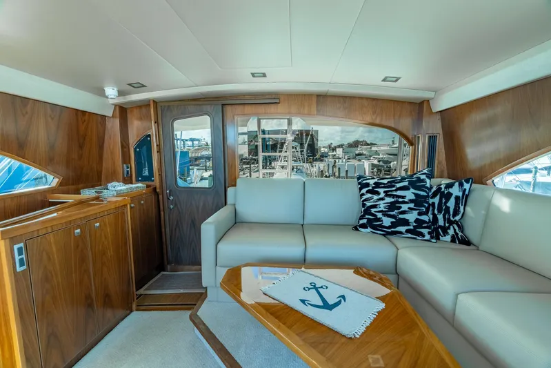 Reel Cents Yacht Photos Pics Luxurious interior of 2019 Viking 80 Enclosed Bridge yacht with elegant seating and nautical decor.