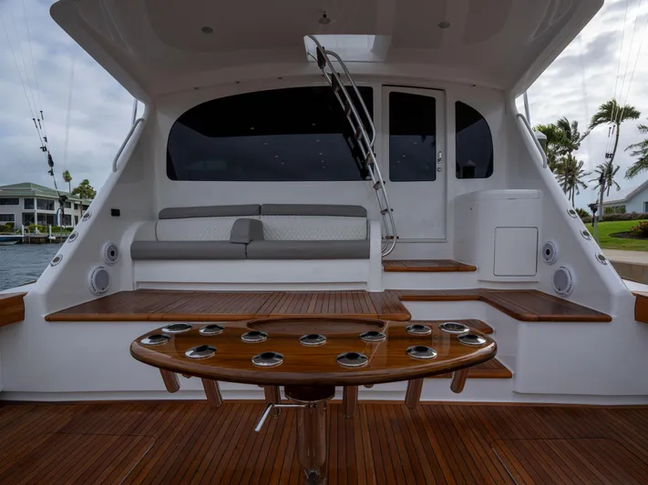 Reel Cents Yacht Photos Pics 2019 Viking 80 Enclosed Bridge yacht deck with seating and rod holders.