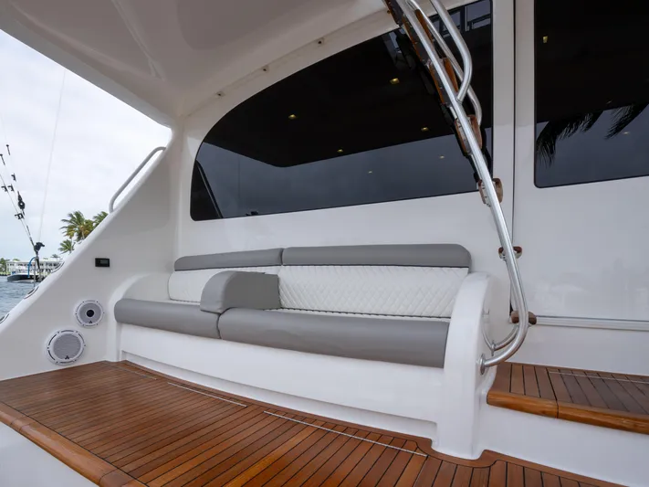 Reel Cents Yacht Photos Pics Luxurious seating area on 2019 Viking 80 Enclosed Bridge yacht with teak flooring.