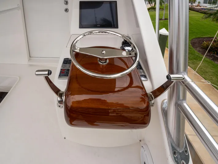 Reel Cents Yacht Photos Pics Steering wheel of 2019 Viking 80 Enclosed Bridge yacht with polished wood finish.