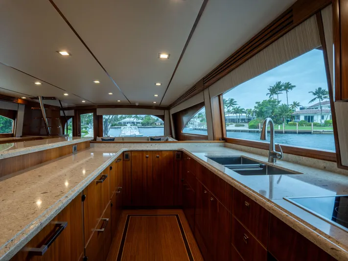 Reel Cents Yacht Photos Pics Luxurious kitchen interior of 2019 Viking 80 Enclosed Bridge yacht with modern amenities.