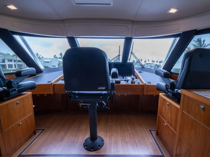 Reel Cents Yacht Photos Pics 2019 Viking 80 Enclosed Bridge helm with panoramic windows and luxurious seating.