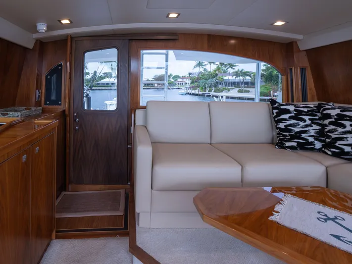 Reel Cents Yacht Photos Pics Luxurious interior of 2019 Viking 80 Enclosed Bridge yacht with elegant wood and leather furnishings.