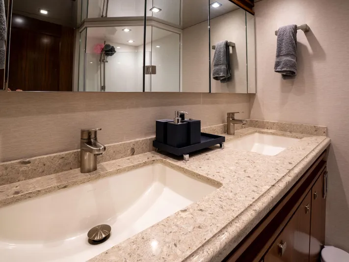 Reel Cents Yacht Photos Pics Luxurious bathroom in 2019 Viking 80 Enclosed Bridge yacht with dual sinks and elegant fixtures.