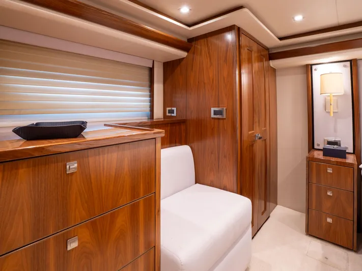 Reel Cents Yacht Photos Pics Luxurious wood-paneled interior of 2019 Viking 80 Enclosed Bridge yacht cabin.