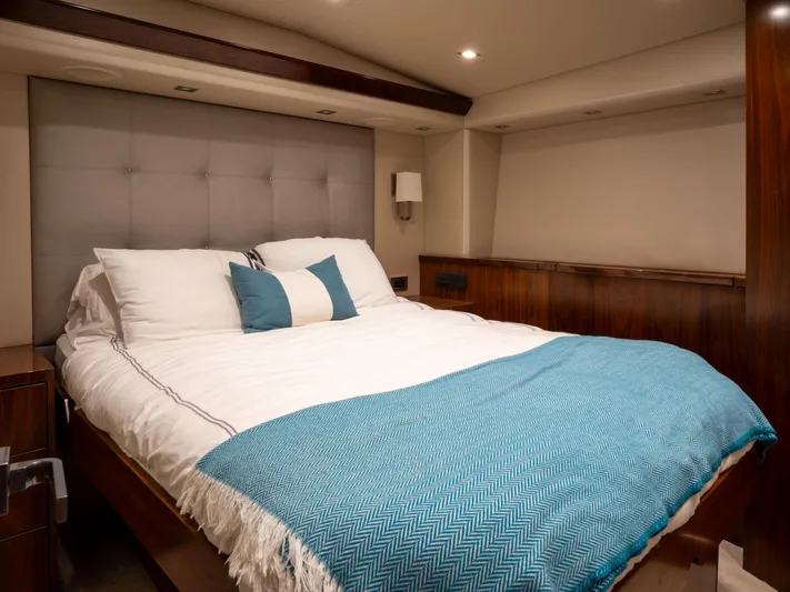 Reel Cents Yacht Photos Pics Luxurious bedroom interior of 2019 Viking 80 Enclosed Bridge yacht with elegant bedding.