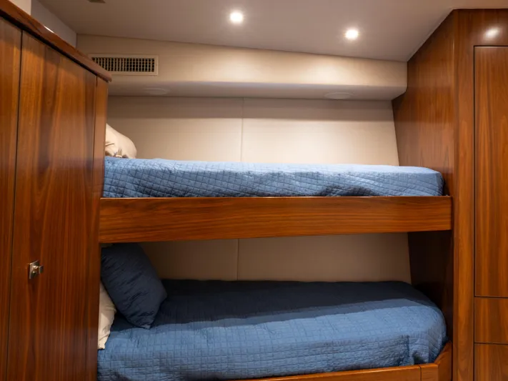 Reel Cents Yacht Photos Pics Bunk beds with blue bedding in 2019 Viking 80 Enclosed Bridge yacht cabin.