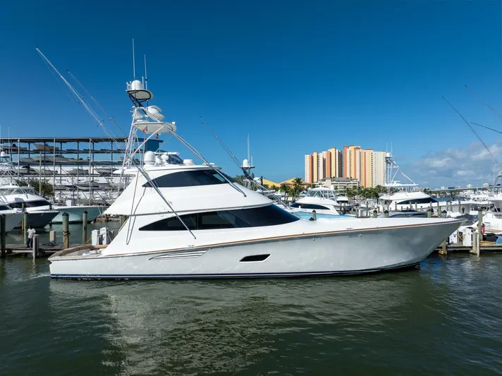 Reel Cents Yacht Photos Pics 2019 Viking 80 Enclosed Bridge yacht docked in marina, clear blue sky background.