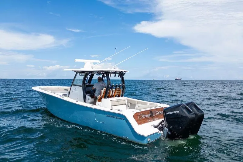 Change Clothes Yacht Photos Pics 2023 Sportsman Open 322 Center Console boat cruising on open ocean waters.