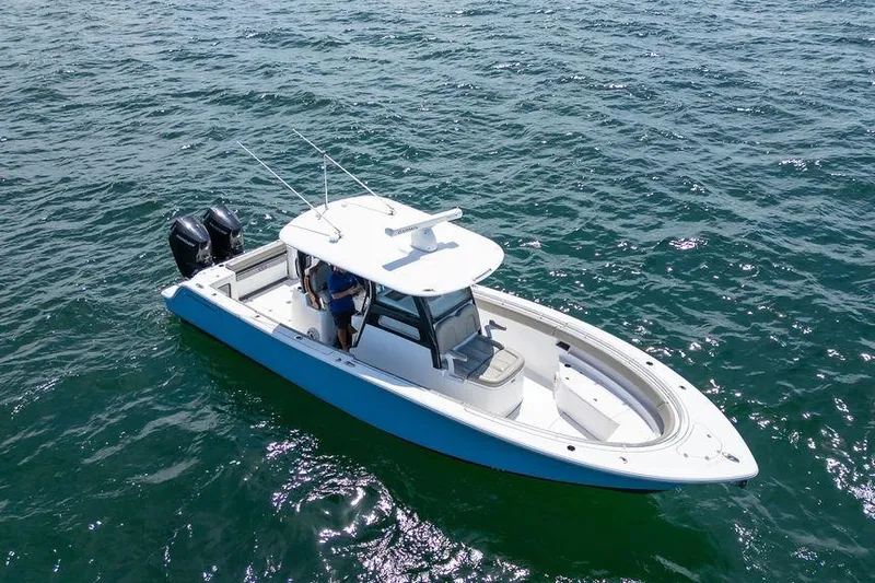 Change Clothes Yacht Photos Pics 2023 Sportsman Open 322 Center Console boat on open water, aerial view.