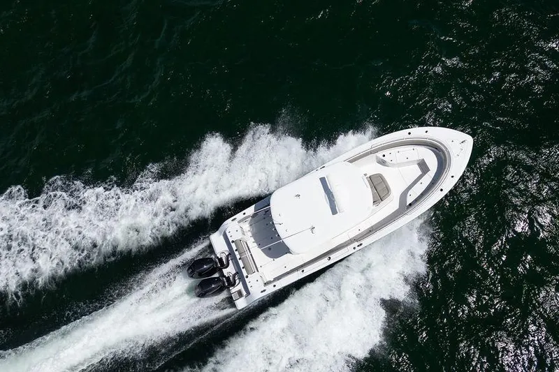 Change Clothes Yacht Photos Pics 2023 Sportsman Open 322 Center Console boat cruising on open water.