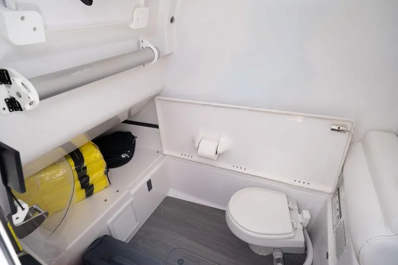 Change Clothes Yacht Photos Pics 2023 Sportsman Open 322 Center Console interior with toilet and storage area.