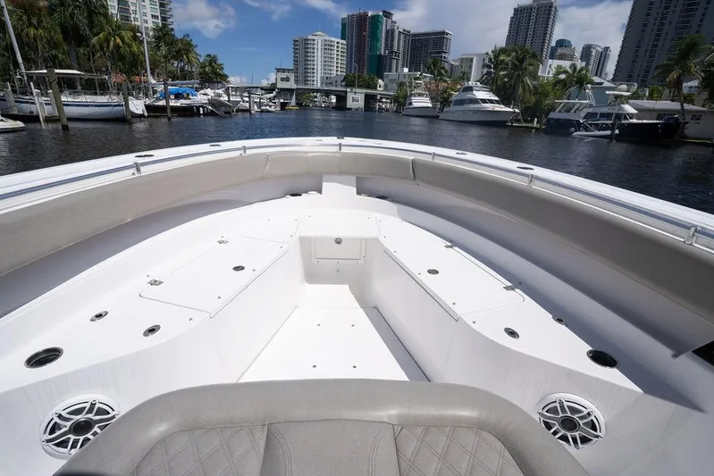 Change Clothes Yacht Photos Pics 2023 Sportsman Open 322 Center Console boat docked in a marina with city skyline.