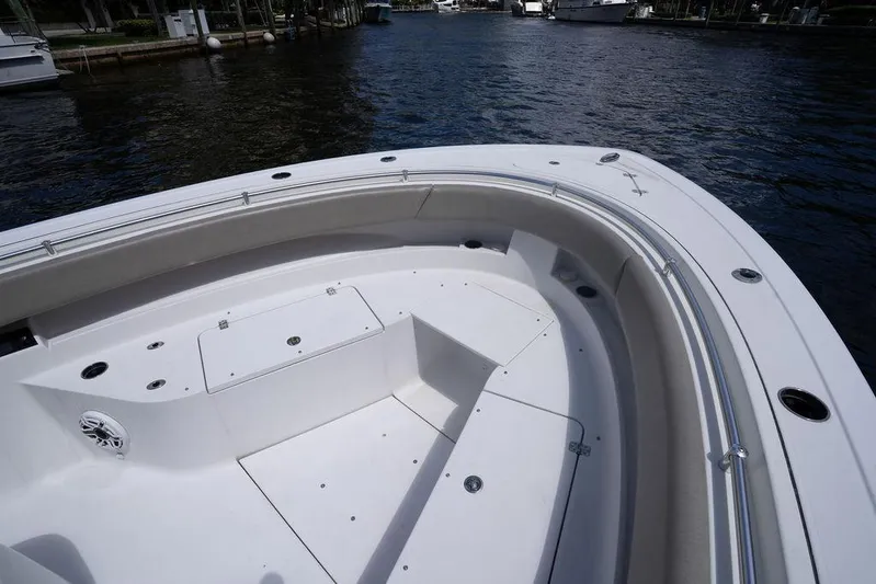 Change Clothes Yacht Photos Pics 2023 Sportsman Open 322 Center Console boat, spacious deck view, docked on calm water.
