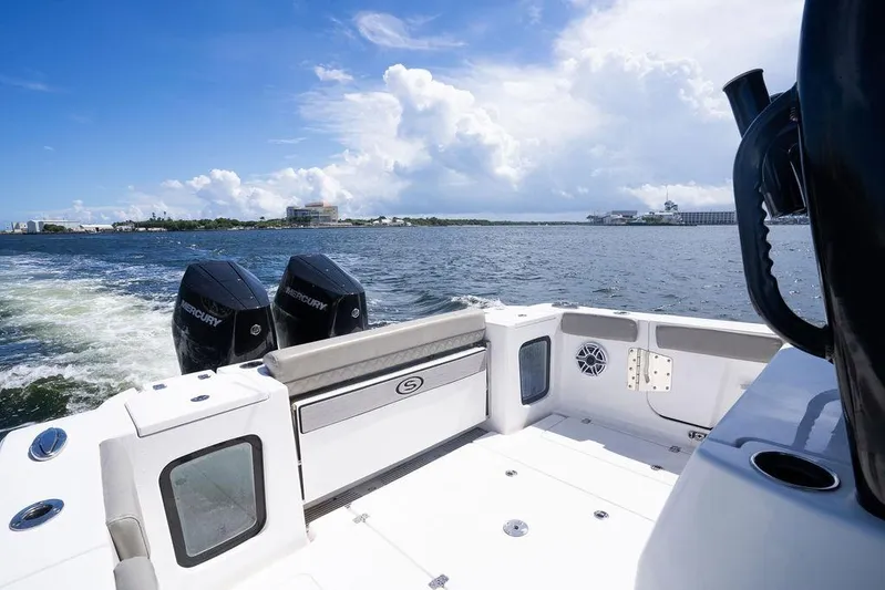 Change Clothes Yacht Photos Pics 2023 Sportsman Open 322 Center Console boat on water, featuring dual Mercury engines.