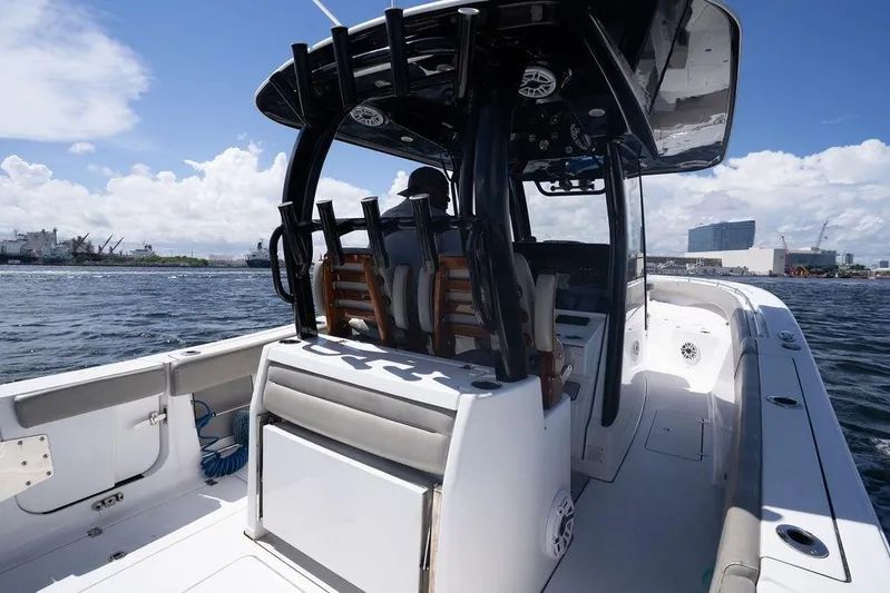 Change Clothes Yacht Photos Pics 2023 Sportsman Open 322 Center Console boat on water, cityscape in background.